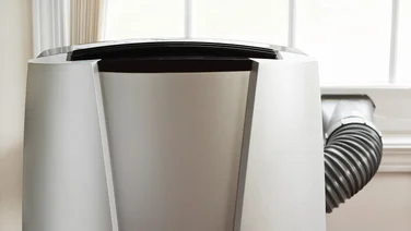 portable heat pump air conditioner with exhaust hose sticking out window