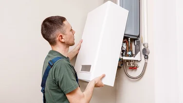 Someone installing a gas boiler