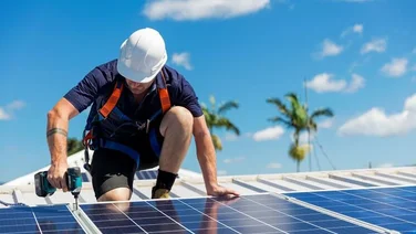 Solar panel installer on a sunny day