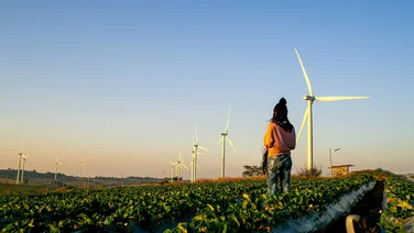 woman stood near wind turbines