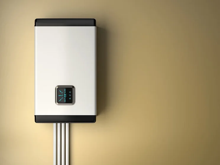 An electric boiler against a beige background