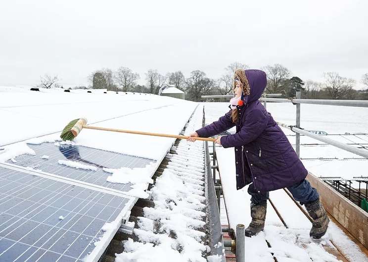 Cleaning snow of solar panels.