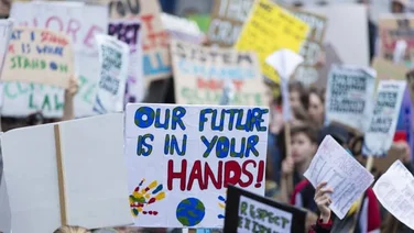 climate change protesters wave placards