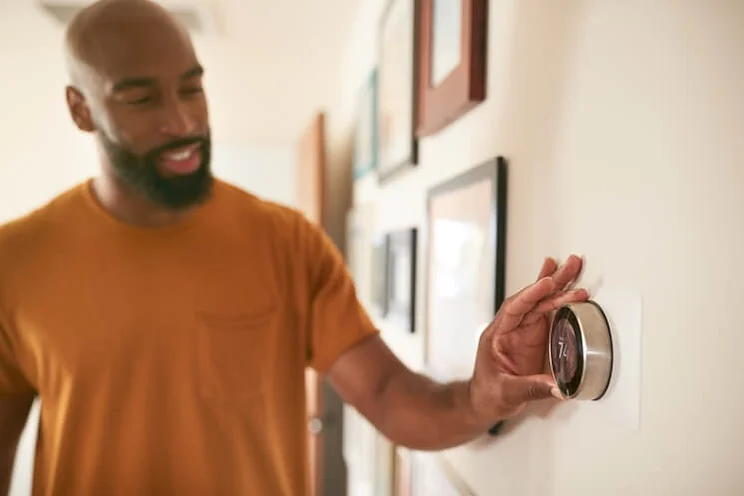 Person changing temperature at home