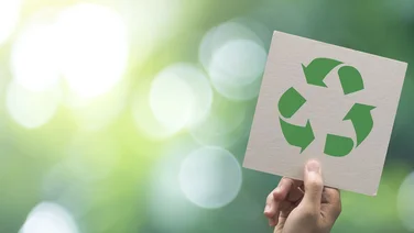 hand holding recycling symbol