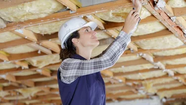 woman installs loft insulation