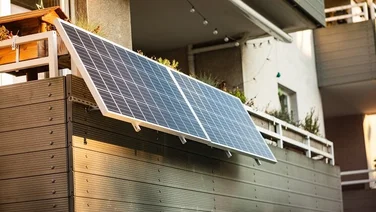 solar panels suspended from a balcony with wooden barrier